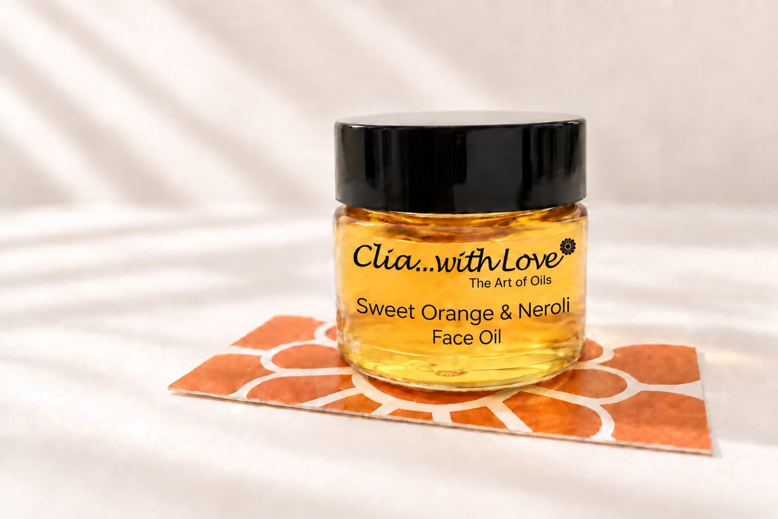 Sweet Orange & Neroli Face Oil with the Clia...with Love and The Art of Oils label, on an orange flower card.